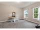 Bright bedroom featuring carpet, natural light from the two windows, and a decorative table at 1508 Banks Brooke Dr, Raleigh, NC 27603