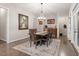 Open dining room with hardwood floors, stylish chandelier and large adjacent doors at 1508 Banks Brooke Dr, Raleigh, NC 27603