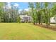 Landscaped front lawn leading to a charming two-story home nestled among mature trees at 1508 Banks Brooke Dr, Raleigh, NC 27603