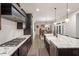 Modern kitchen showcasing a large island, gas range, stainless steel appliances, and dining area in the background at 1508 Banks Brooke Dr, Raleigh, NC 27603
