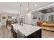 Open kitchen with island, granite countertops, stainless appliances, farm sink, and pendant lighting at 1508 Banks Brooke Dr, Raleigh, NC 27603