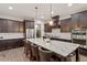 Bright, well-appointed kitchen featuring stainless steel appliances, dark cabinetry, and an expansive island at 1508 Banks Brooke Dr, Raleigh, NC 27603