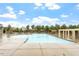 Community pool area with ample seating, umbrellas, and manicured landscaping at 1508 Banks Brooke Dr, Raleigh, NC 27603
