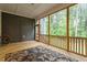 Screened-in porch with wood flooring, providing an inviting outdoor living space, with a view of the backyard at 1508 Banks Brooke Dr, Raleigh, NC 27603