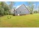 Image showcases a rear view of the house, emphasizing the well-maintained lawn at 1508 Banks Brooke Dr, Raleigh, NC 27603