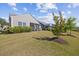 Expansive green backyard with mature trees, shrubs, and well-maintained lawn at 1533 Santa Lucia St, Wake Forest, NC 27587