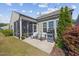 Cozy screened porch and patio area with grill, seating and lush landscaping in the backyard at 1533 Santa Lucia St, Wake Forest, NC 27587