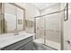Modern bathroom features a glass-enclosed shower, gray vanity, and neutral tile work at 1533 Santa Lucia St, Wake Forest, NC 27587