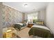 Cozy bedroom with floral wallpaper, two twin beds, and a window offering natural light at 1533 Santa Lucia St, Wake Forest, NC 27587
