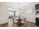 Inviting dining area with wainscoting detail adjacent to the living room with backyard views at 1533 Santa Lucia St, Wake Forest, NC 27587
