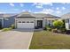 Charming single-story home featuring a two-car garage, well-maintained lawn and colorful landscaping at 1533 Santa Lucia St, Wake Forest, NC 27587