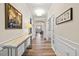 Elegant hallway with hardwood floors, decorative molding, and artwork, leading to the living areas at 1533 Santa Lucia St, Wake Forest, NC 27587