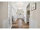 Inviting hallway featuring wood floors, panel molding, and stylish decor, leading to various rooms at 1533 Santa Lucia St, Wake Forest, NC 27587