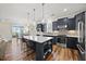 Gourmet kitchen with dark cabinets, stainless steel appliances, and an island with bar seating at 1533 Santa Lucia St, Wake Forest, NC 27587