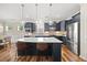 Modern kitchen featuring dark cabinetry, an island with seating, and stainless steel appliances at 1533 Santa Lucia St, Wake Forest, NC 27587