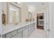 Elegant bathroom with double vanity, stone countertops, and a well-organized walk-in closet at 1533 Santa Lucia St, Wake Forest, NC 27587