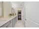 Bright bathroom with double vanity, stone countertops, and access to a walk-in closet at 1533 Santa Lucia St, Wake Forest, NC 27587