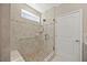 Modern shower featuring pebble floor, hand shower, and seat, complemented by neutral tile work at 1533 Santa Lucia St, Wake Forest, NC 27587