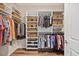 Organized walk-in closet with built-in shelves, rods, and baskets for efficient storage at 1533 Santa Lucia St, Wake Forest, NC 27587