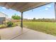 Backyard featuring a covered patio overlooking a spacious yard and a wood fence perimeter at 173 Longbow Dr, Middlesex, NC 27557
