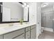 Well-lit bathroom with double sinks, neutral colors, and a spacious shower with tiled walls at 173 Longbow Dr, Middlesex, NC 27557