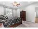Comfortable bedroom with a ceiling fan, natural light, and a stylish wardrobe cabinet for ample storage at 173 Longbow Dr, Middlesex, NC 27557