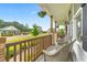 Relaxing front porch with wicker chairs, wooden railings, and hanging flower baskets at 173 Longbow Dr, Middlesex, NC 27557