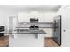 This kitchen features white cabinets, stainless steel appliances, and a functional center island with bar seating at 173 Longbow Dr, Middlesex, NC 27557