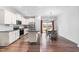 Bright, open kitchen featuring white cabinetry, stainless steel appliances, and adjacent dining area with backyard access at 173 Longbow Dr, Middlesex, NC 27557