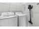 Functional laundry room with a modern washer, dryer, and convenient wire shelving for storage at 173 Longbow Dr, Middlesex, NC 27557