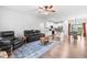 Cozy living room with black leather furniture, hardwood floors, and an open layout at 173 Longbow Dr, Middlesex, NC 27557