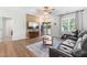 Inviting living room boasts a decorative wall, ceiling fan, stylish rug, and comfortable leather sofa at 173 Longbow Dr, Middlesex, NC 27557