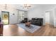 Comfortable living room with hardwood floors, black leather furniture, and plenty of natural light at 173 Longbow Dr, Middlesex, NC 27557
