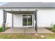 Back patio featuring a retractable shade and a sliding glass door entrance to the home at 173 Longbow Dr, Middlesex, NC 27557