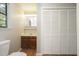 Cozy bathroom featuring a vanity with storage, mirror, and adjacent closet for all your essentials at 2012 Stadium Dr, Durham, NC 27705