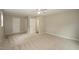 Spacious bedroom featuring neutral carpeting, ceiling fan, and convenient access to other areas at 2012 Stadium Dr, Durham, NC 27705
