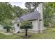Charming home exterior featuring a well-maintained lawn, lush trees, and a quaint entrance at 2012 Stadium Dr, Durham, NC 27705