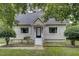 Charming home with white siding, landscaped front yard, and inviting front porch with white stairs at 2012 Stadium Dr, Durham, NC 27705