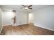 Spacious living area with hardwood floors, ceiling fan, and staircase access to upper levels at 2012 Stadium Dr, Durham, NC 27705