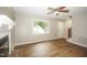 Bright living room with hardwood floors, large window, and fireplace, creating a cozy atmosphere at 2012 Stadium Dr, Durham, NC 27705