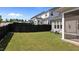 Spacious backyard featuring a well-manicured lawn, dark fence, and cozy blue Adirondack chairs at 2012 Sweet Samson St, Wake Forest, NC 27587