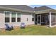 Charming backyard featuring a screened porch, cozy seating, and blue Adirondack chairs at 2012 Sweet Samson St, Wake Forest, NC 27587