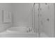 Modern bathroom with a soaking tub, a glass shower, and marble-like tile at 2012 Sweet Samson St, Wake Forest, NC 27587