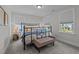 Bedroom features a black iron bed frame, neutral colors, with bench and ample natural light at 2012 Sweet Samson St, Wake Forest, NC 27587