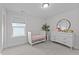 Comfortable Bedroom with a white crib, dresser, and a round mirror, designed for a peaceful environment at 2012 Sweet Samson St, Wake Forest, NC 27587
