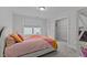 Cozy bedroom with a colorful quilt, a window, and an open closet, perfect for a room at 2012 Sweet Samson St, Wake Forest, NC 27587