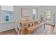 Open dining room featuring a wooden table with a bench, modern art, and natural light at 2012 Sweet Samson St, Wake Forest, NC 27587