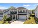 Two-story home with gray siding, black shutters, a well-manicured lawn, and a covered front porch at 2012 Sweet Samson St, Wake Forest, NC 27587