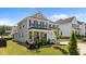 Two-story home featuring a covered front porch, well-manicured landscaping, and an attached two-car garage at 2012 Sweet Samson St, Wake Forest, NC 27587