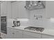 Close-up of a modern kitchen featuring stainless steel appliances, white cabinetry, and sleek countertops at 2012 Sweet Samson St, Wake Forest, NC 27587